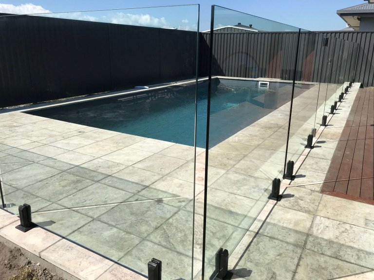 frameless glass pool fence mounted on black spigots