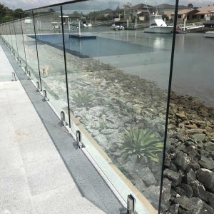 frameless glass pool fence with chrome spigots